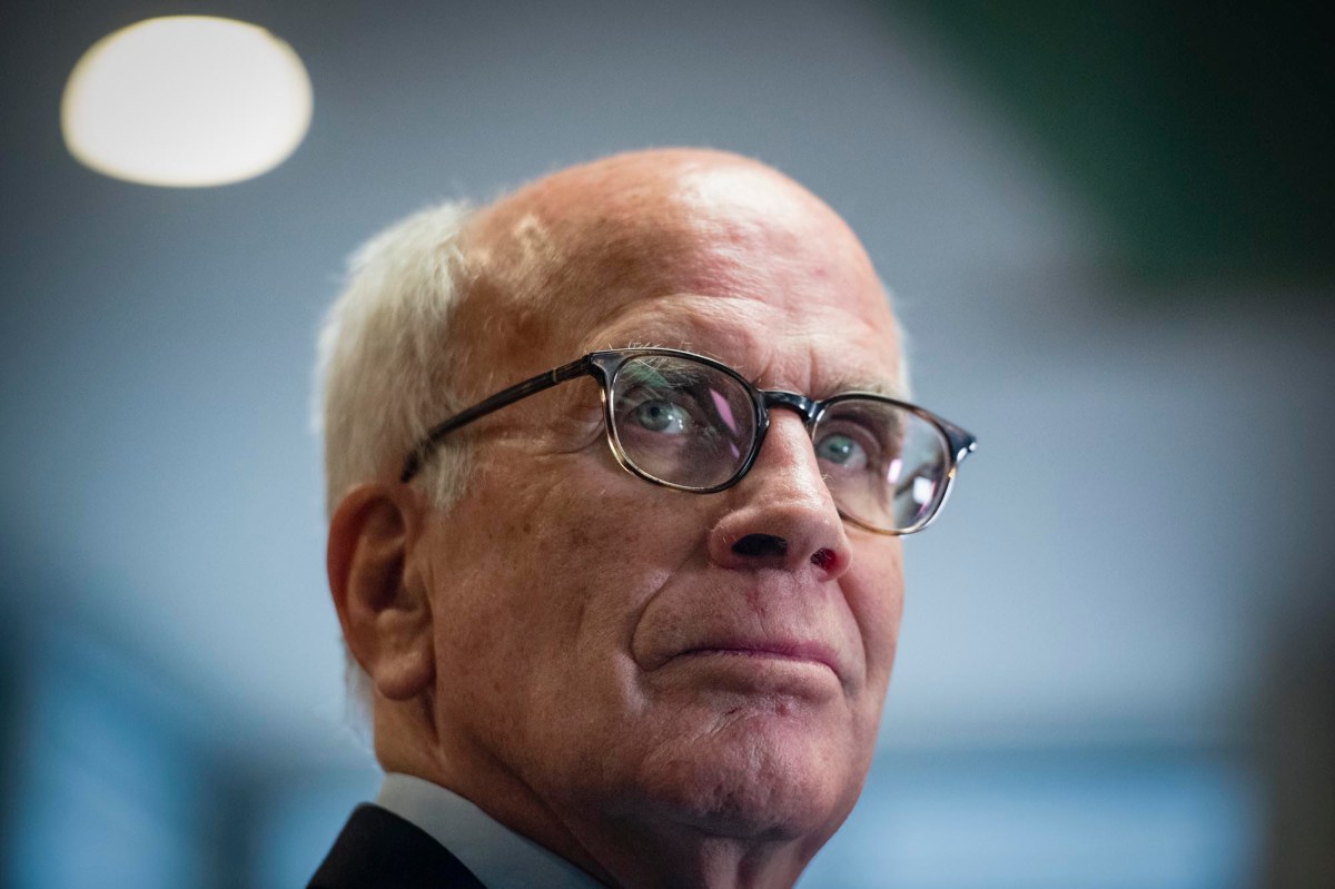 A close up of an older man wearing glasses.