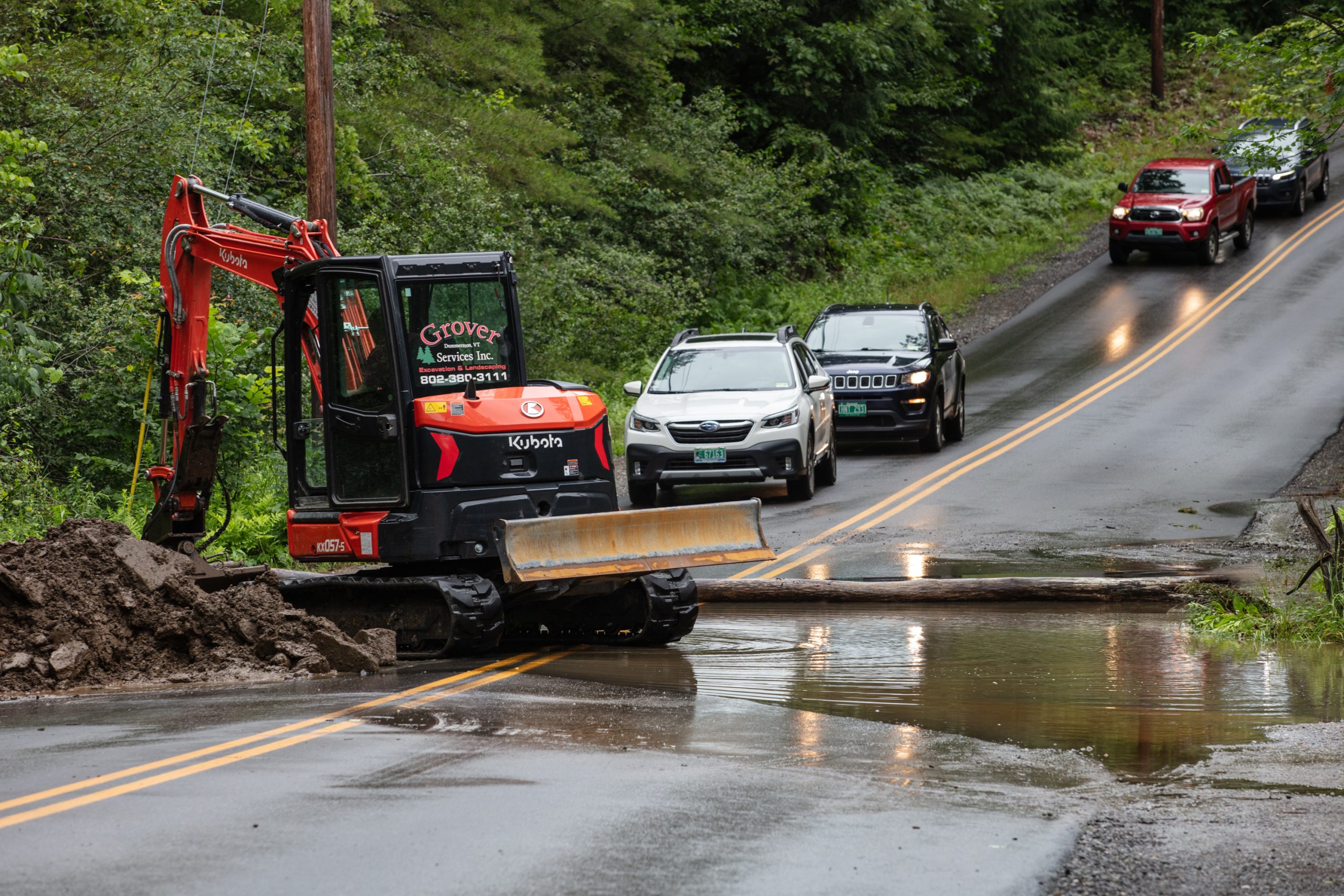 a truck is driving down a muddy road.