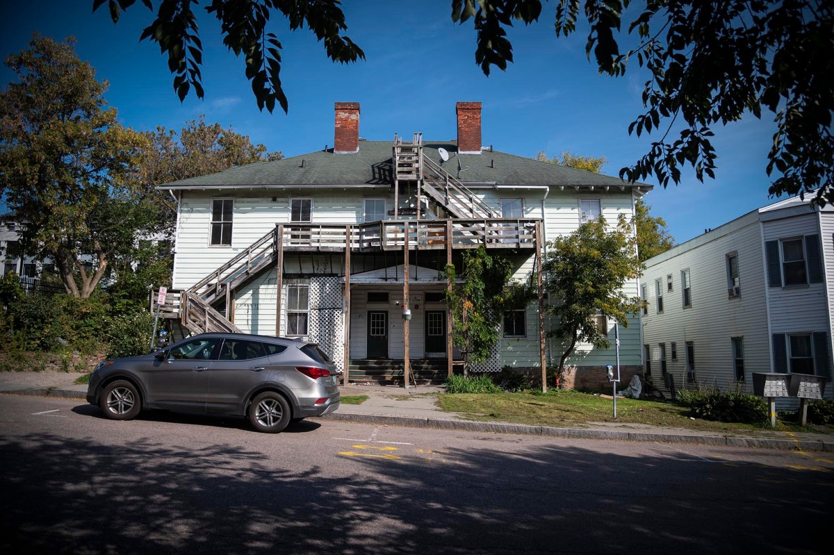 A car is parked in front of a house.