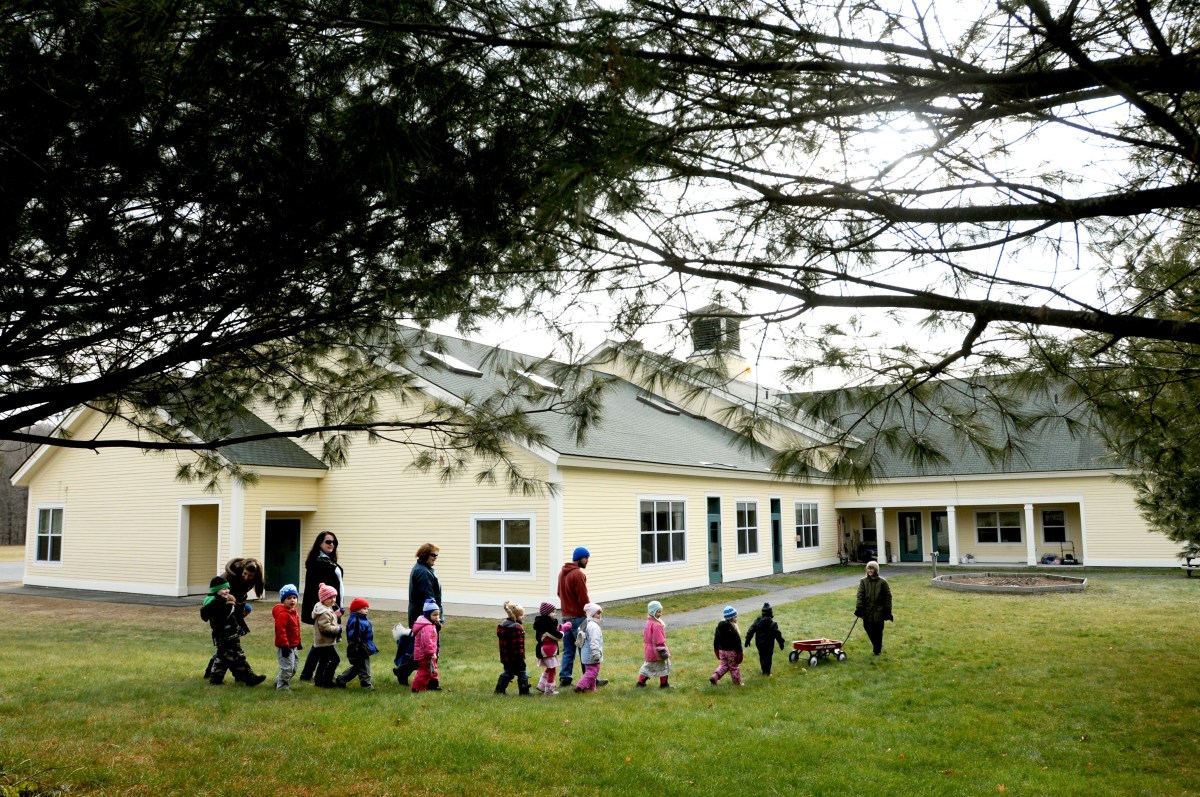 A group of children walking in front of a building.