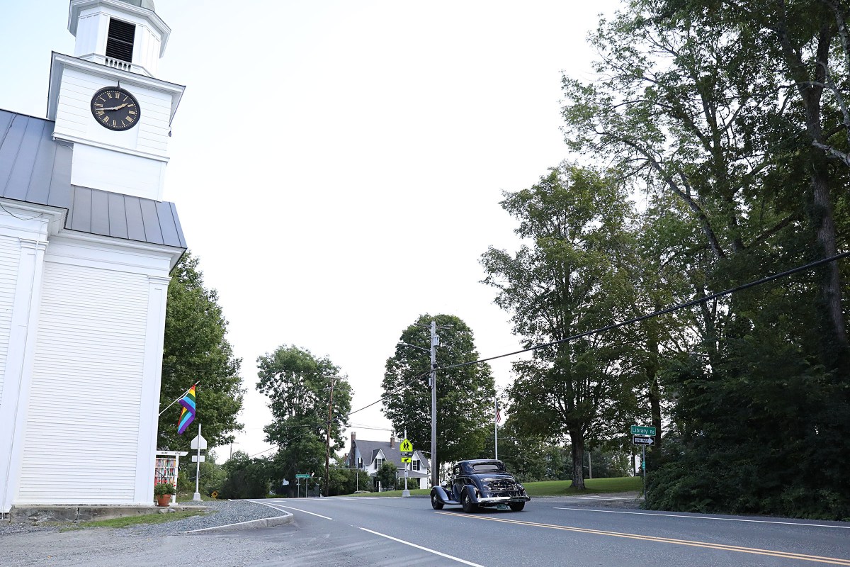 Car drives by church