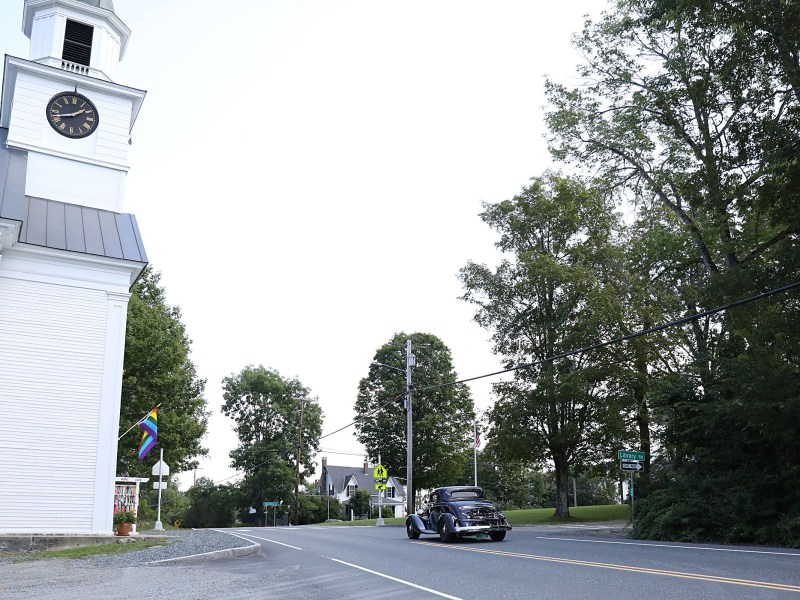 Car drives by church