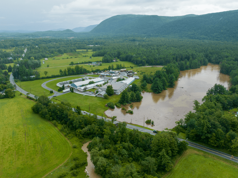 An aerial view of a farm and a river.