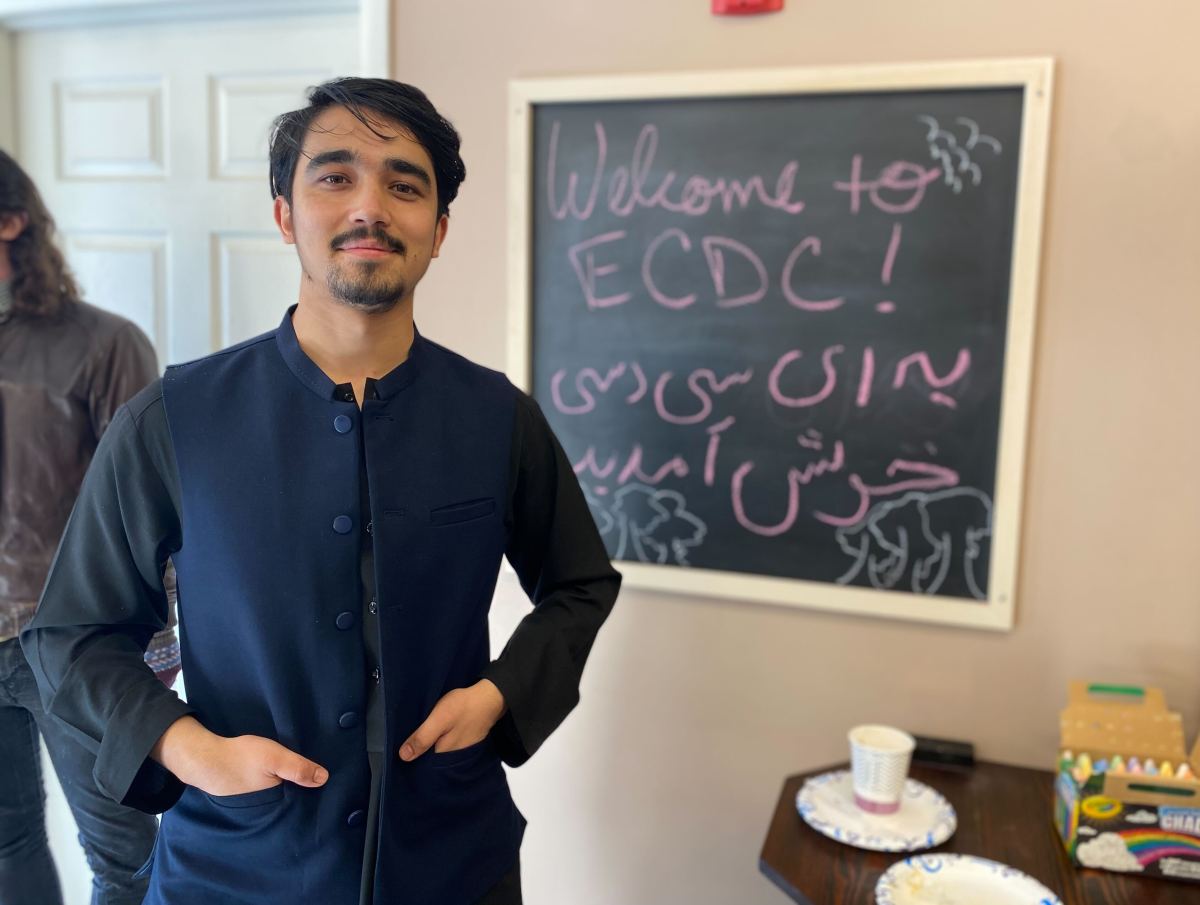A man standing in front of a chalkboard.