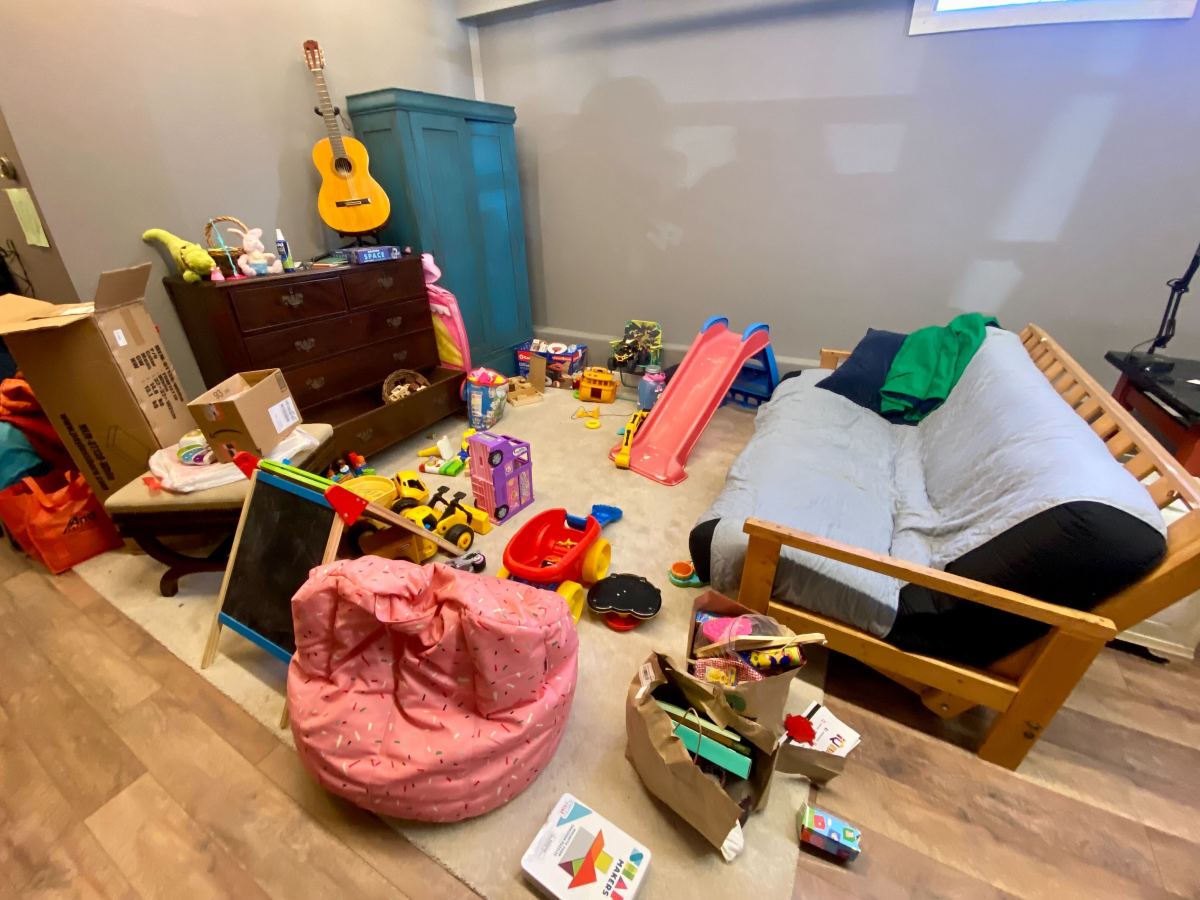 A room full of toys and a couch.