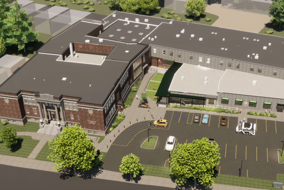 A rendering of a school building with a parking lot.