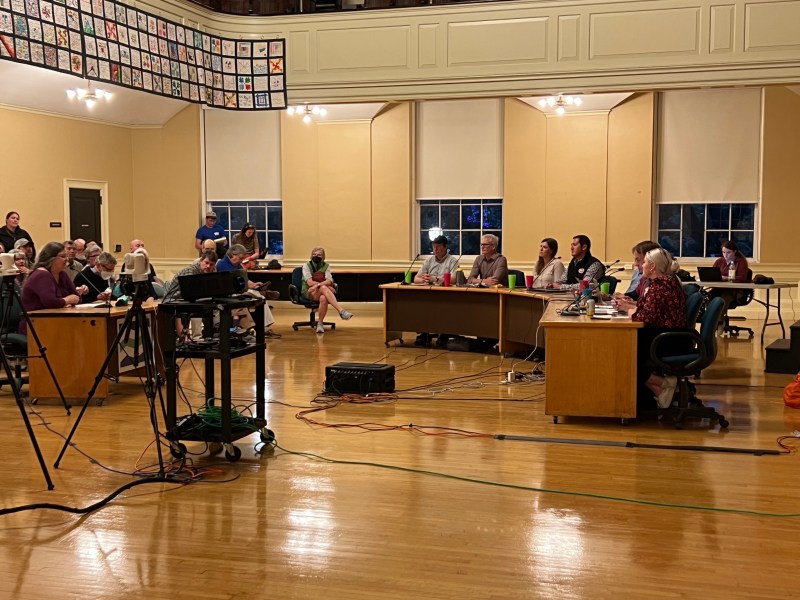 a group of people sitting at tables in a room.