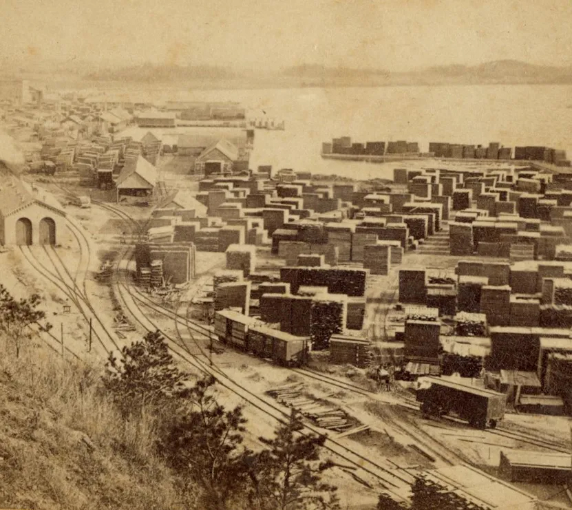 An old photo of Burlington with trains and buildings.