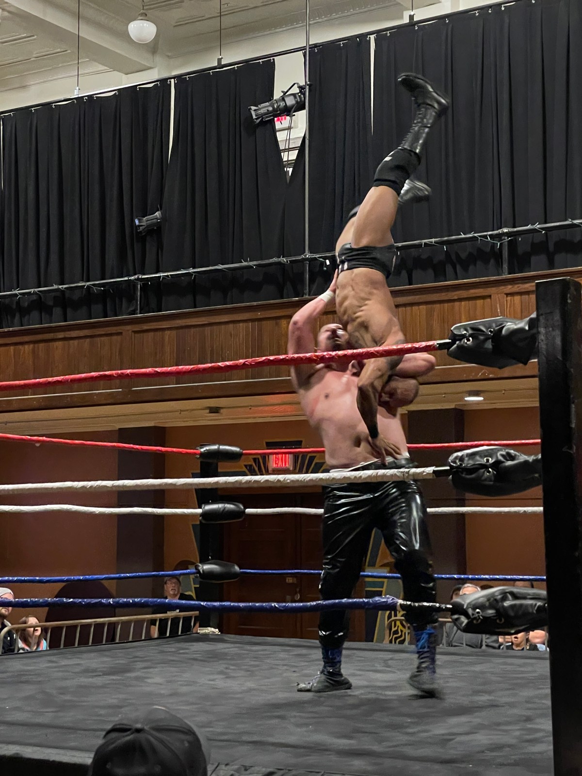 a man in a wrestling ring doing a handstand.