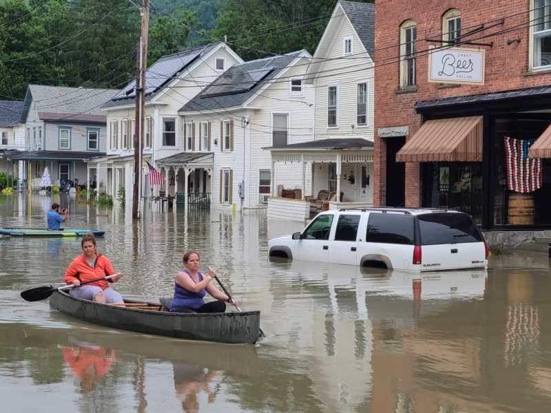 Canoeists on flooded street