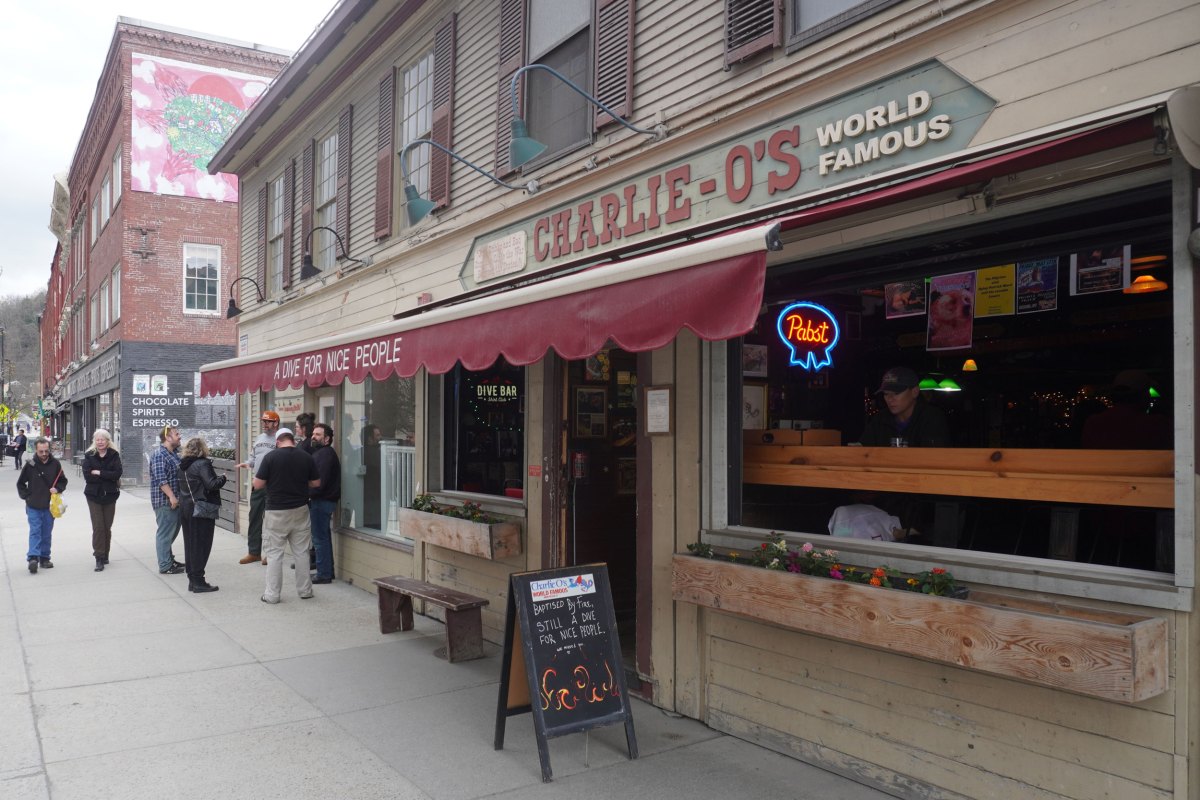 A building with a sign for Charlie O's and a red overhang.