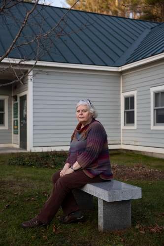 A woman sits on a bench.