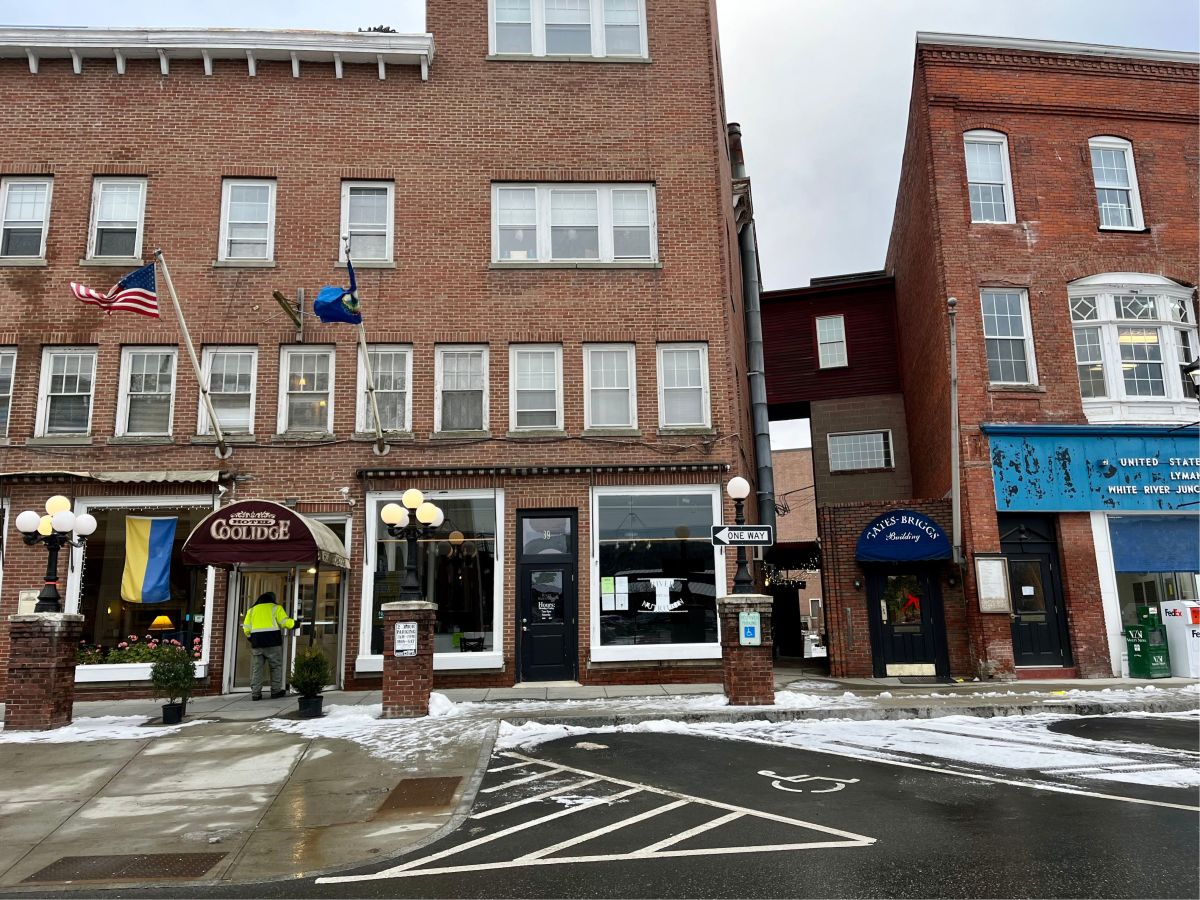 A red brick building on a snowy street.