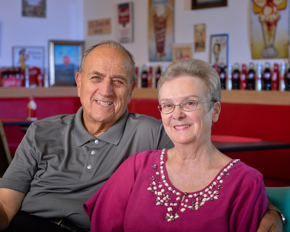 Man with arm around woman