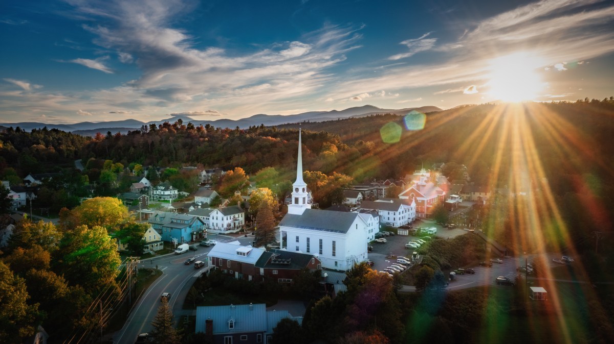 The sunset over a small Vermont town with a white church.