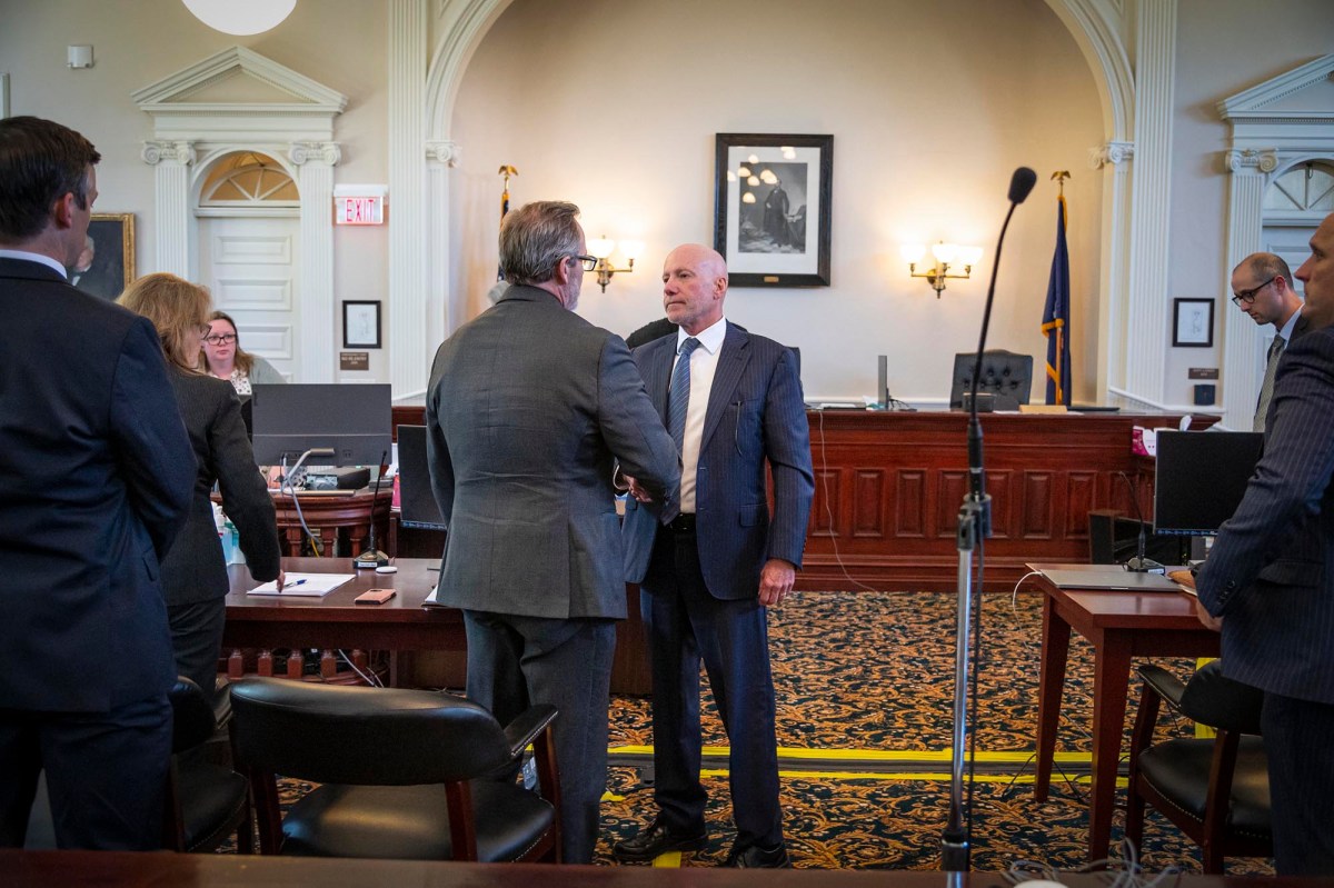a group of men in suits standing in front of a microphone.