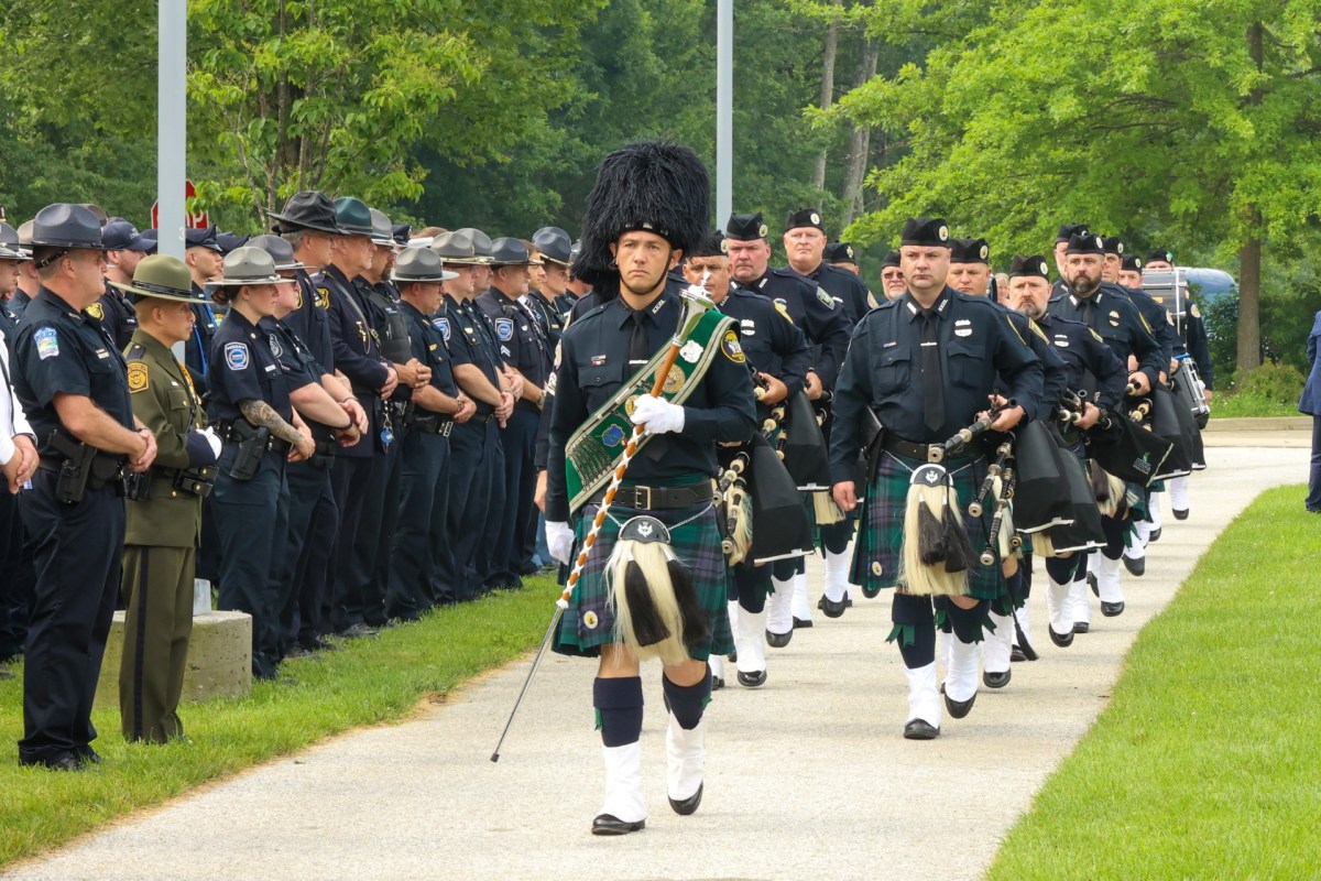 a group of police officers in kilts marching down the street.