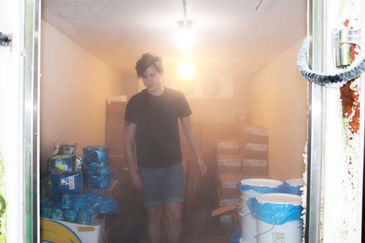 a man standing in a walk-in freezer with a food