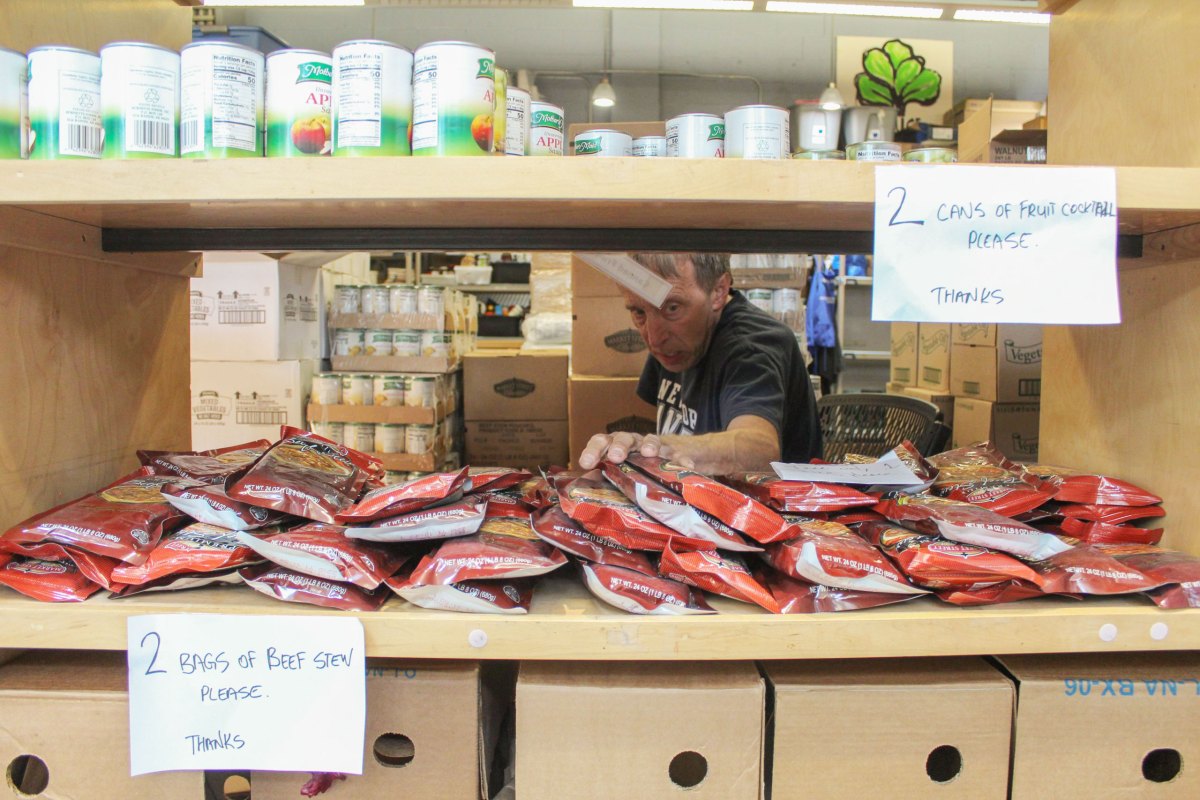 a man in a store looking at boxes of food.