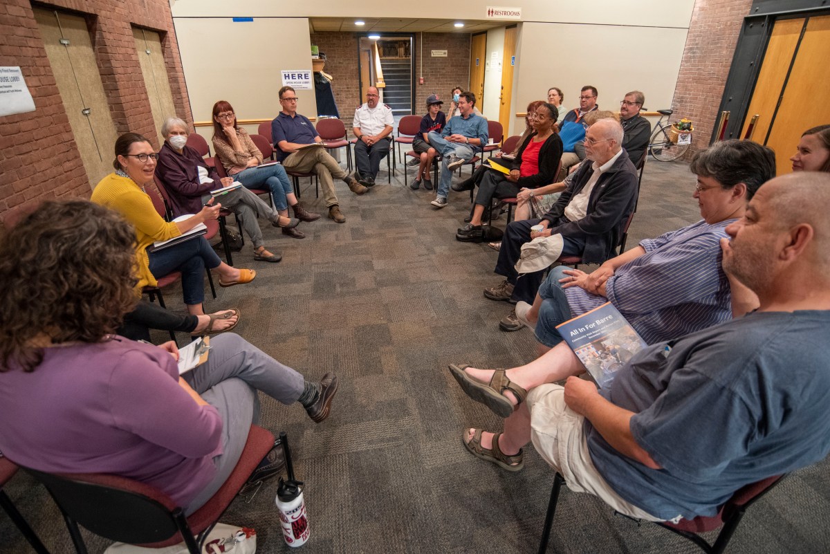 A group of people sitting in a circle in a room.