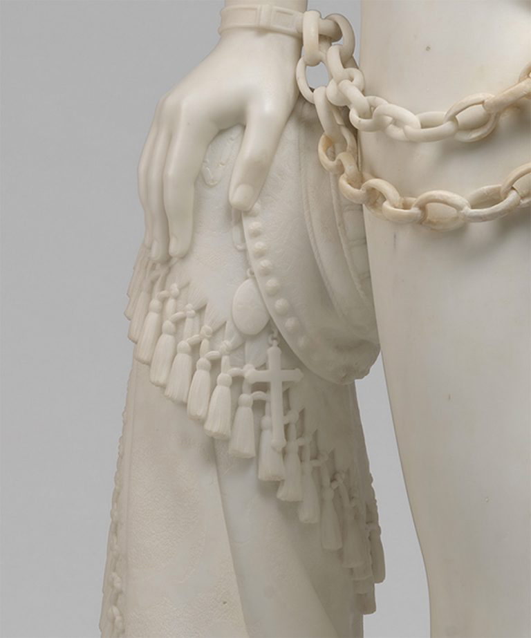A statue of a woman holding a chain.