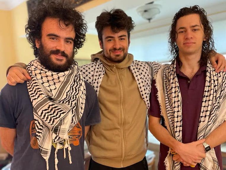 Three young men pose for a photo