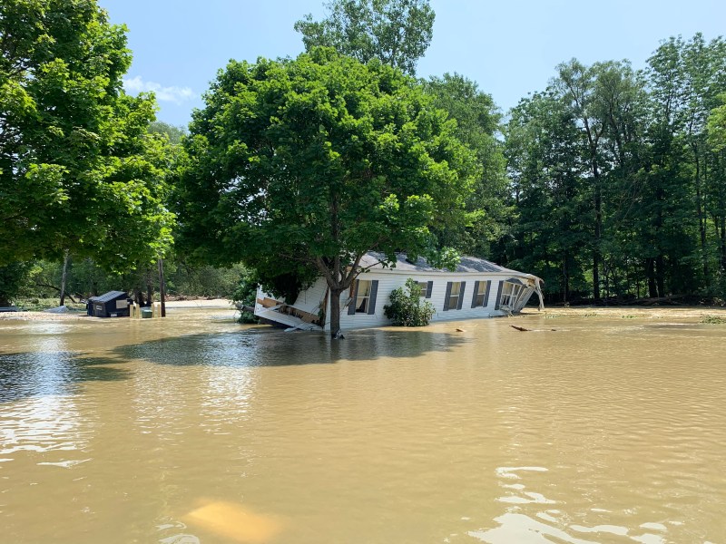 Mobile home pushed downstream in flooding