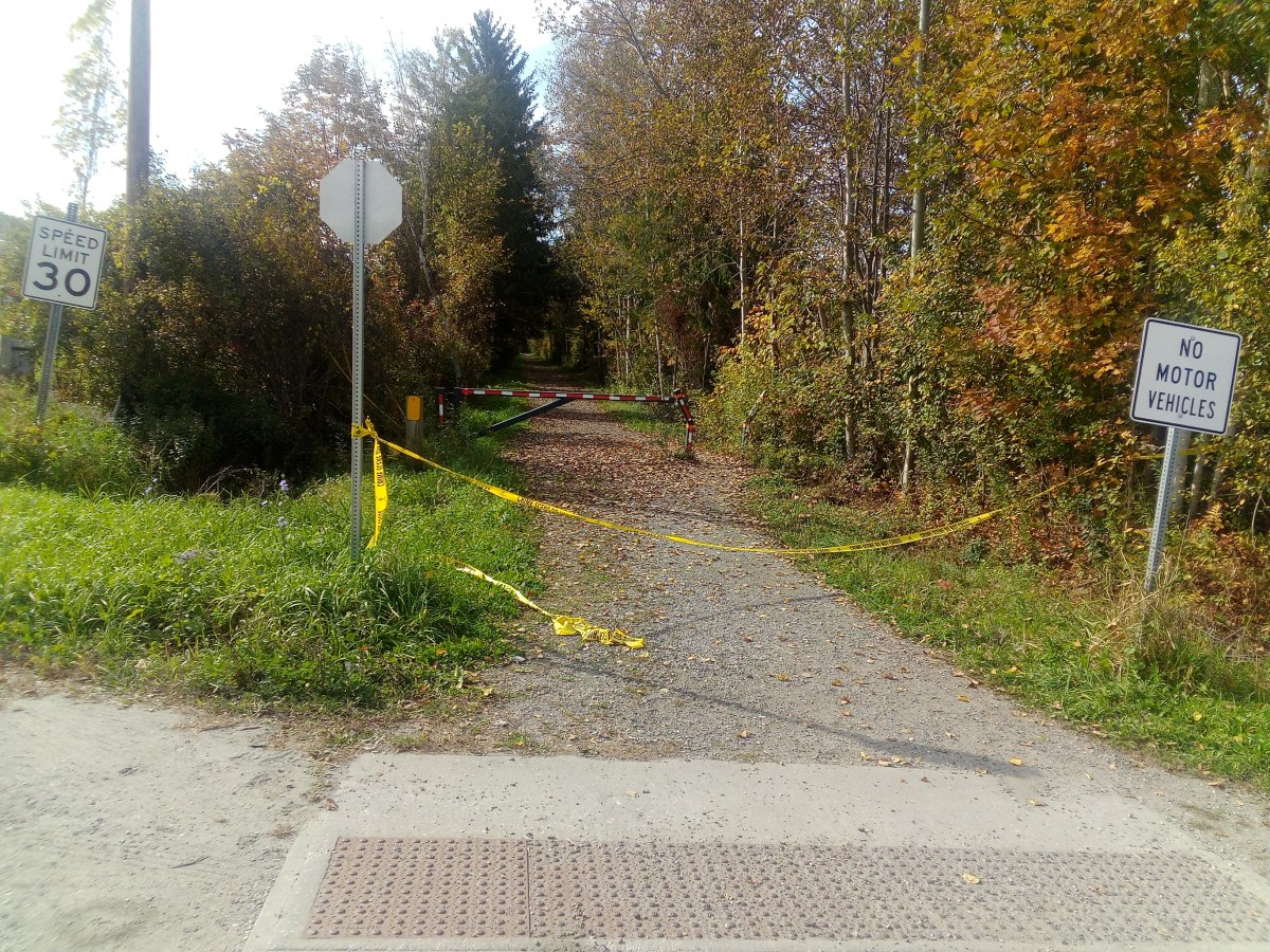 A yellow tape on the side of a road.