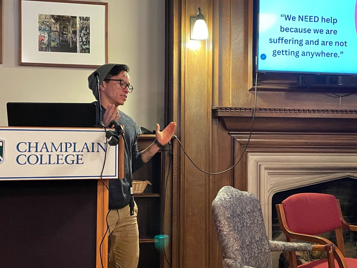 A man standing at a podium in front of a screen.