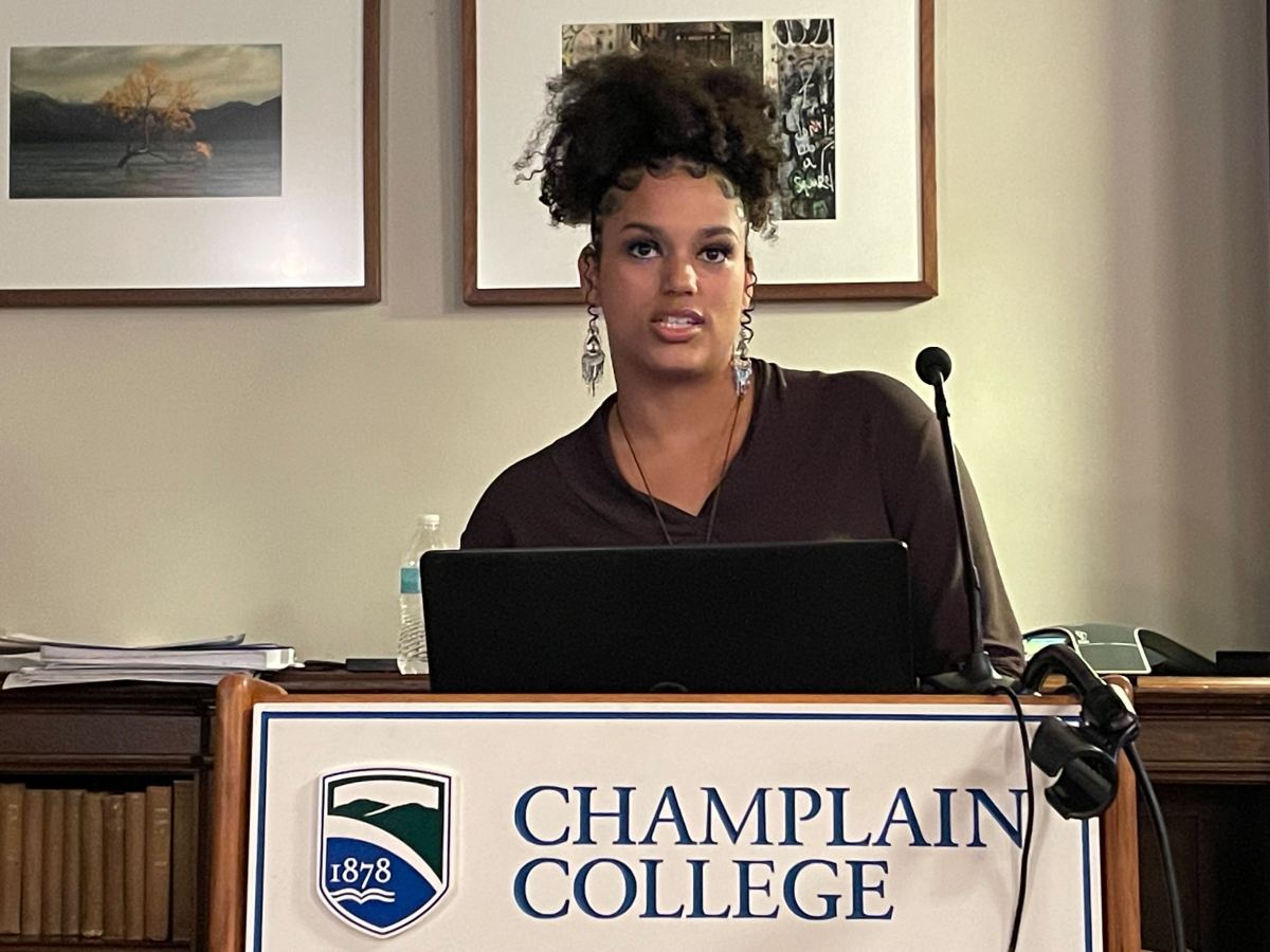 A woman standing in front of a podium with a microphone.