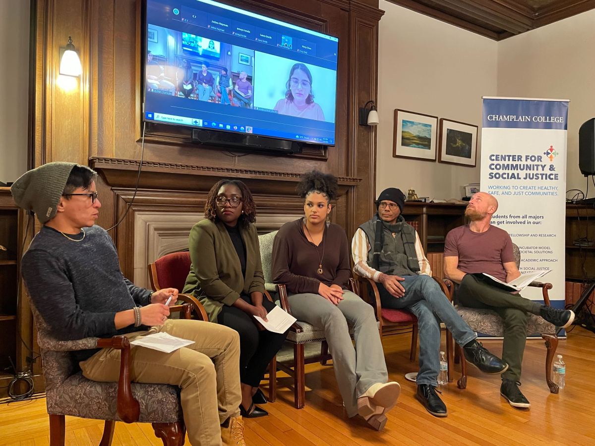 A group of people sitting in chairs in front of a tv.