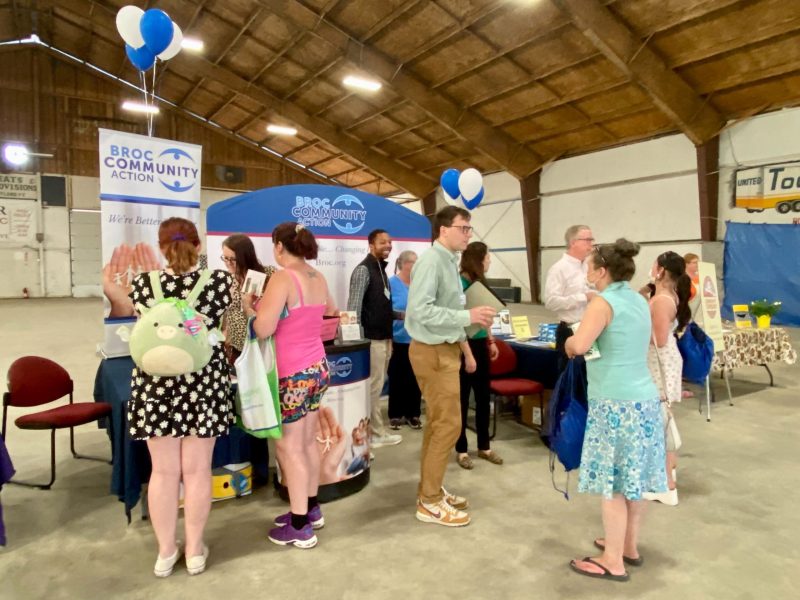 a group of people standing around a table.