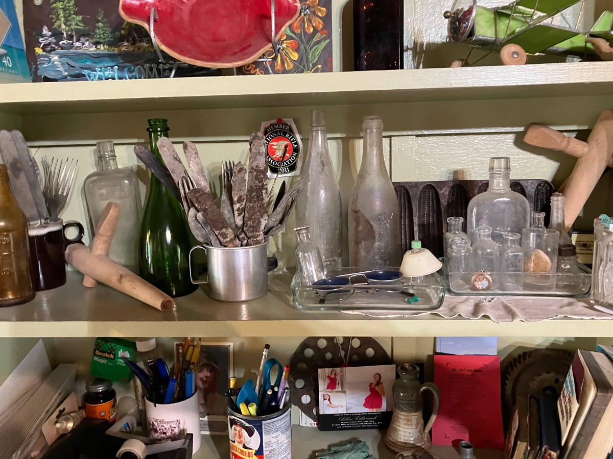 A shelf with a lot of different items on it.