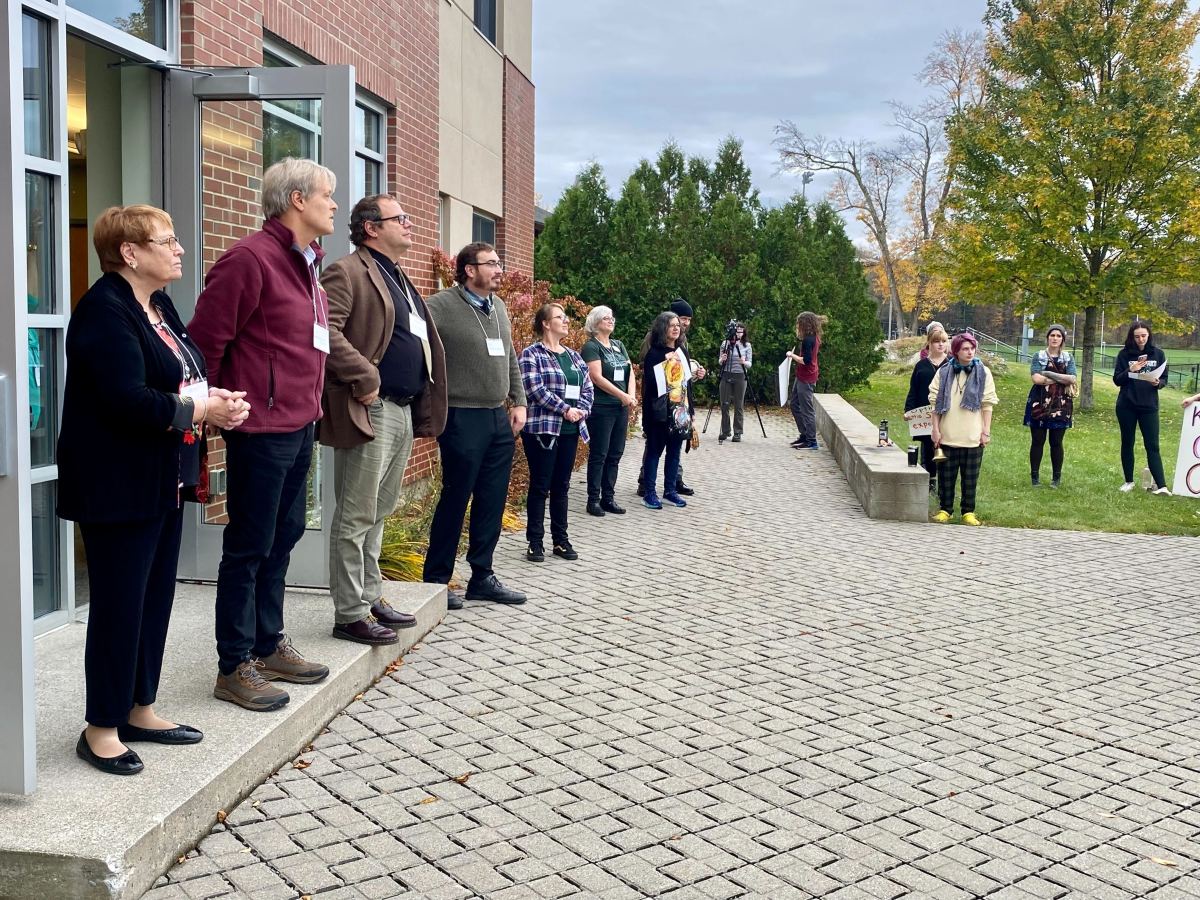A group of people standing outside of a building.