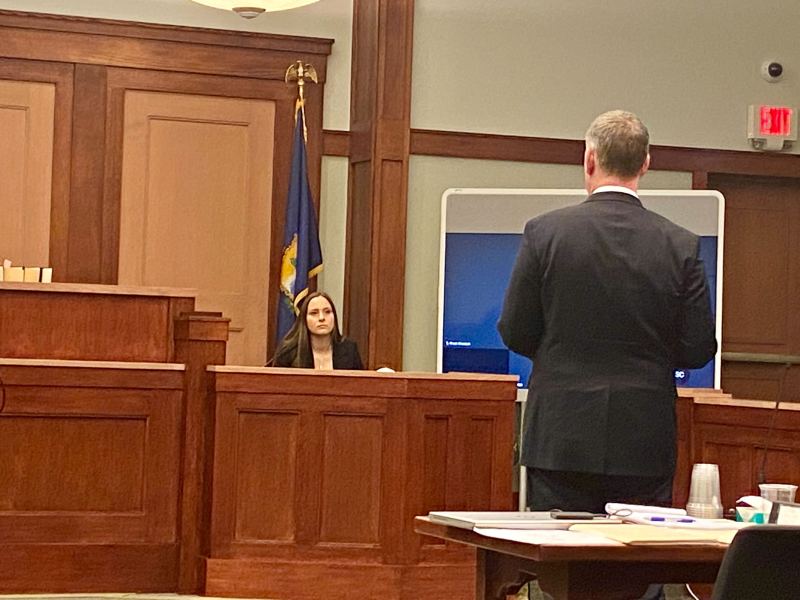 A man talks to a woman in court.