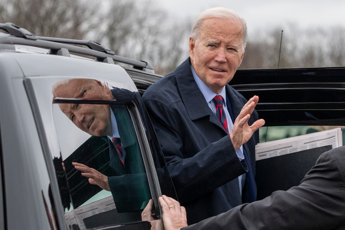 A man waving from a car.