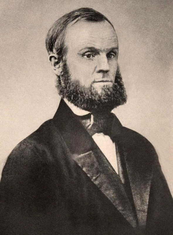 A black and white photo of a man with a beard.