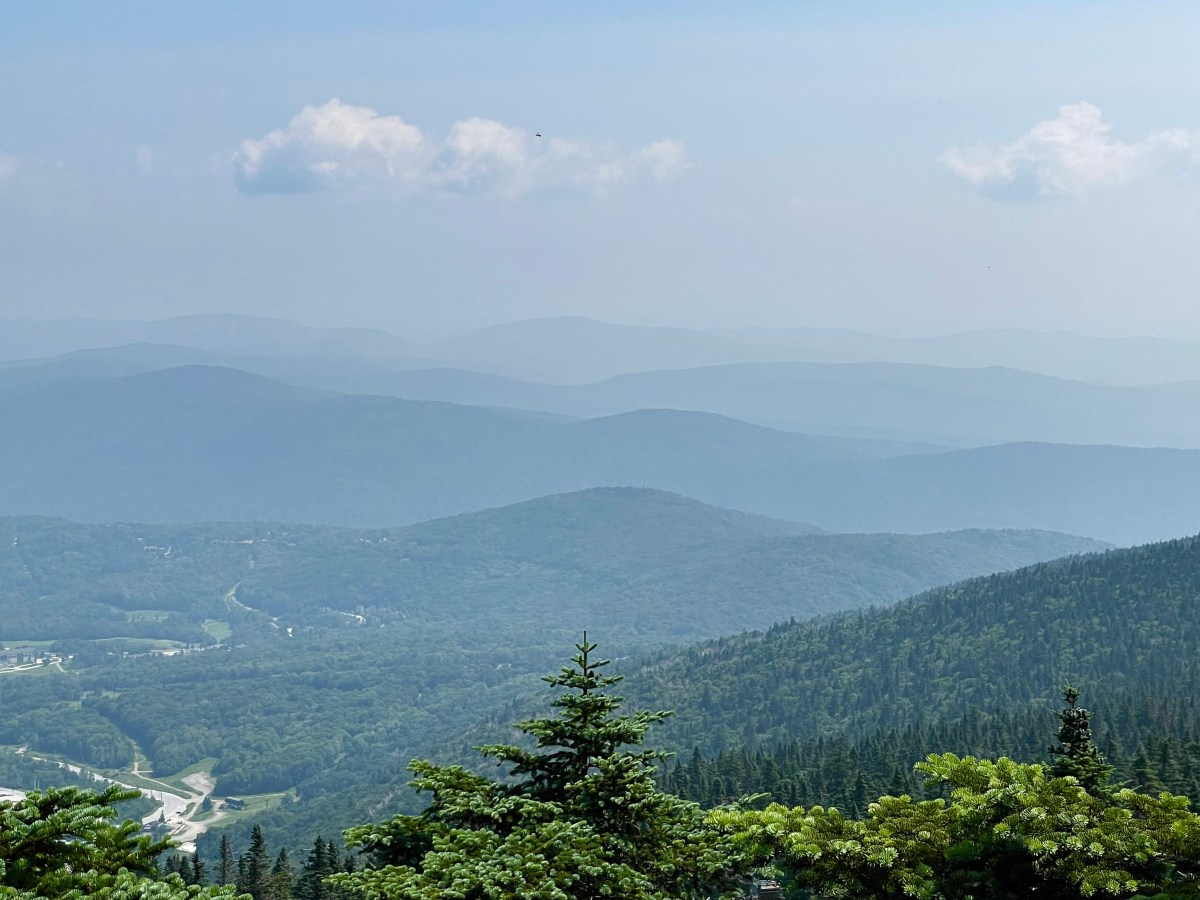 a view of the mountains from atop a mountain.