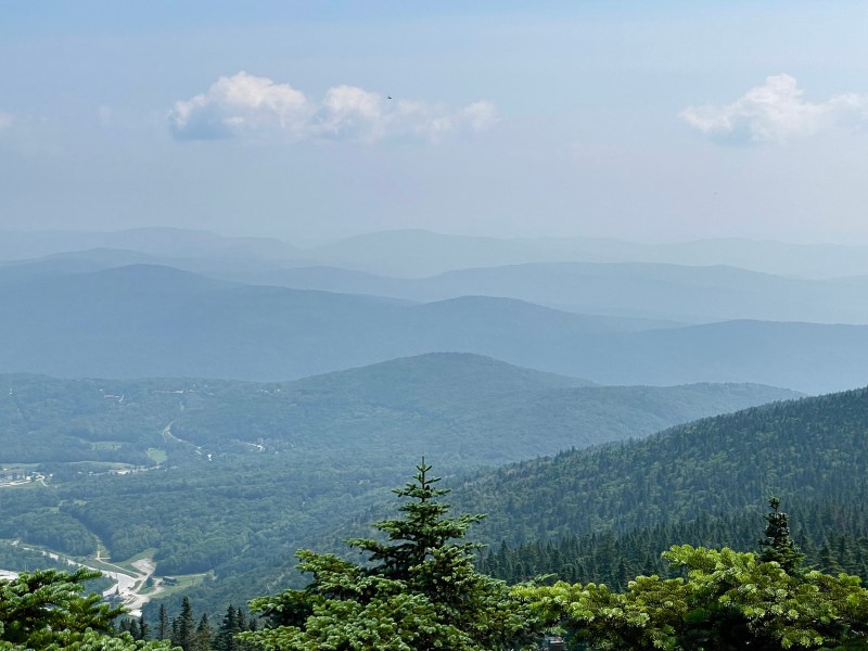 a view of the mountains from atop a mountain.