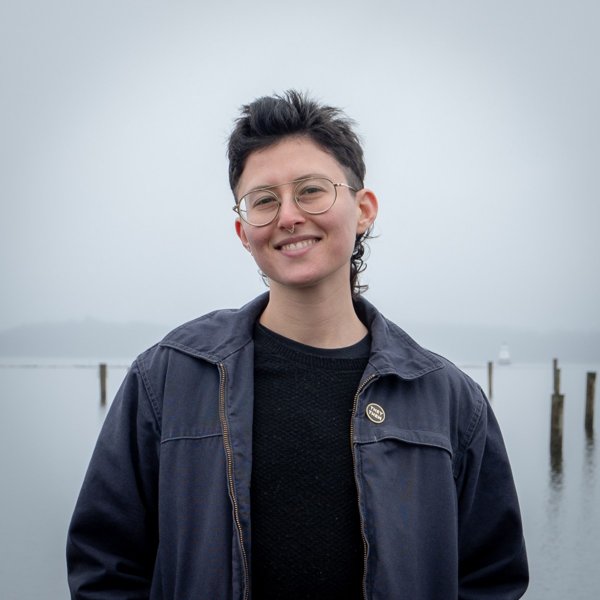 A person standing in front of water.