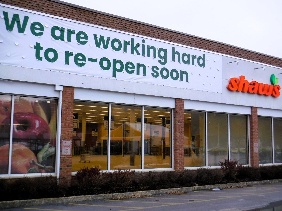 A sign that says we are working hard to reopen soon.