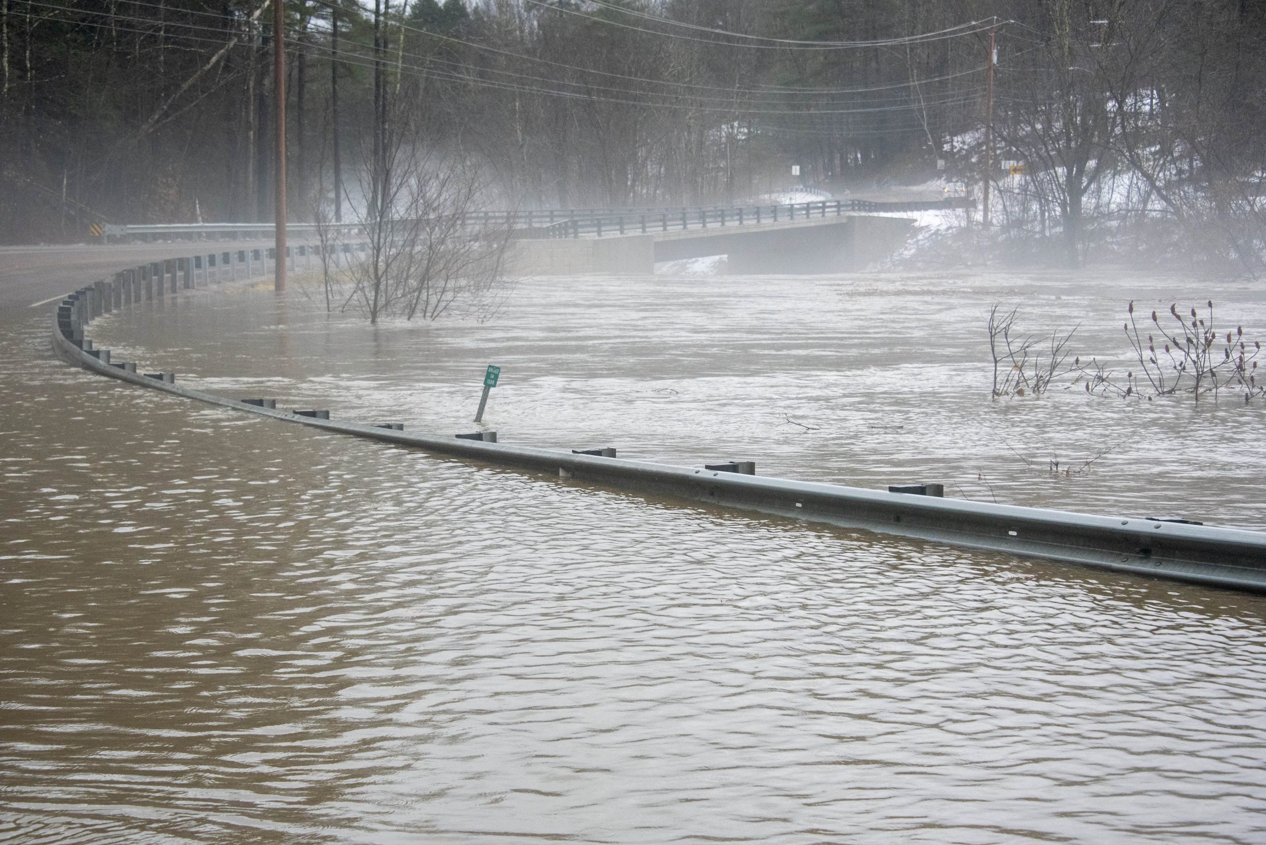 Floodwaters surround a road.