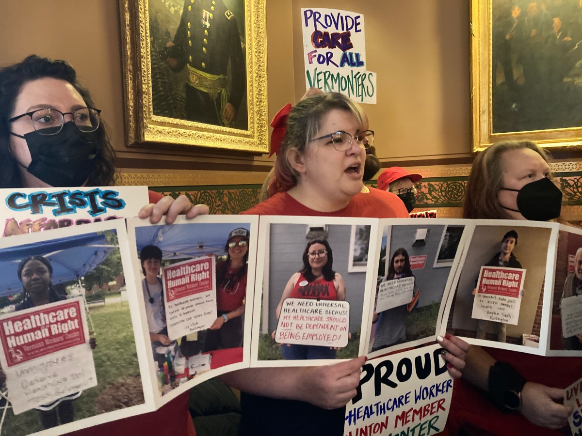 A group of people holding up posters.