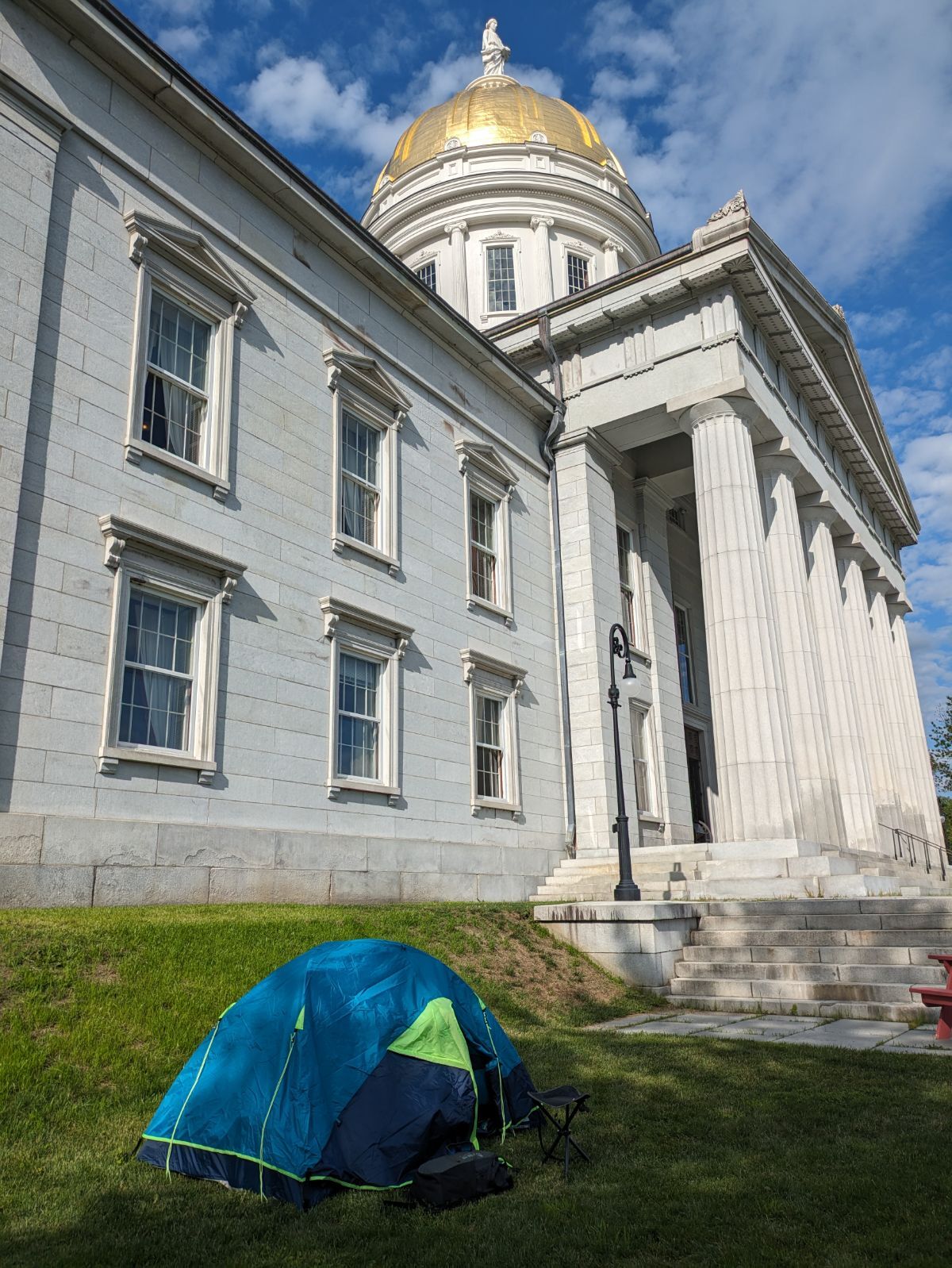 a tent is set up in front of a large building.