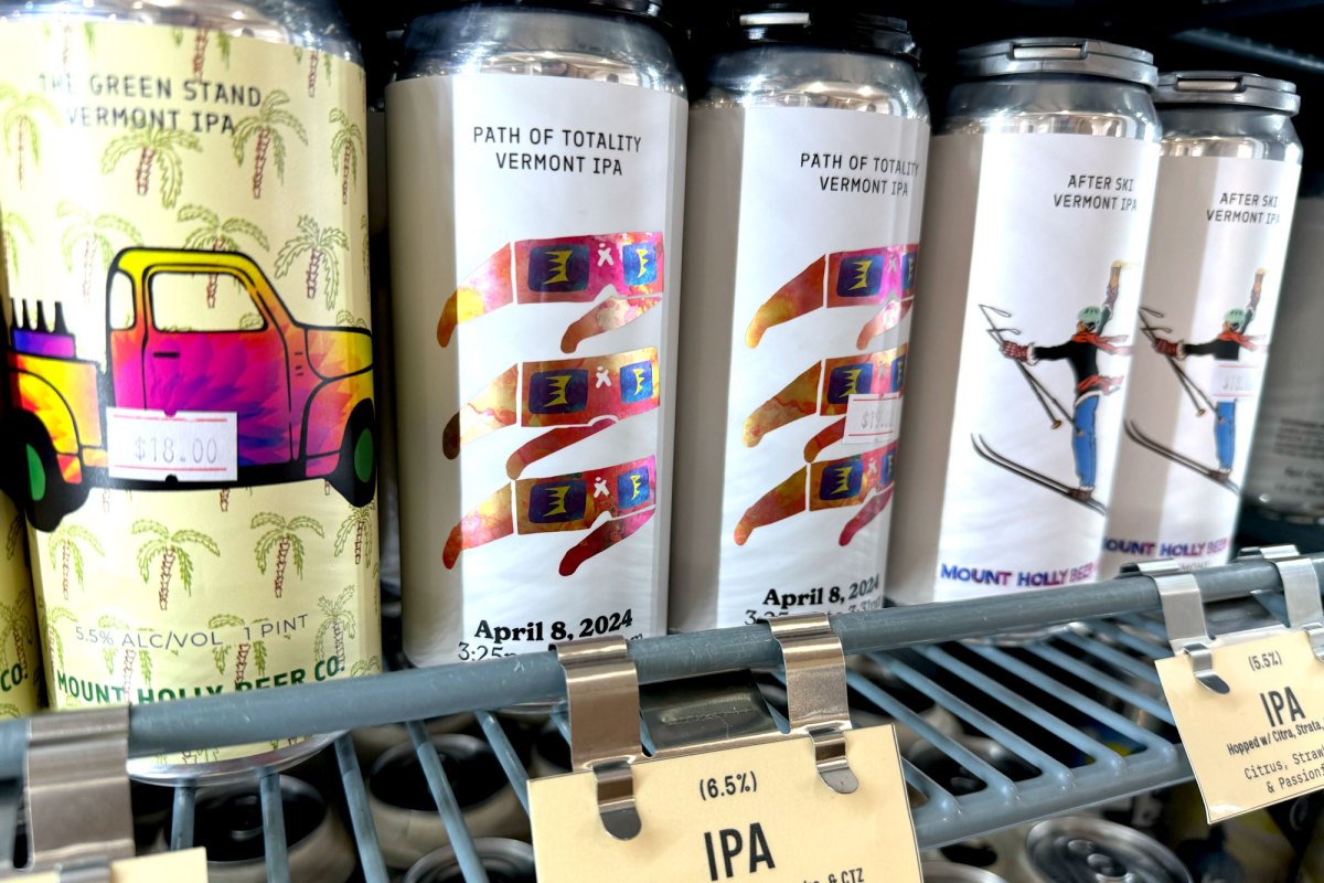 Cans of beer on a shelf.