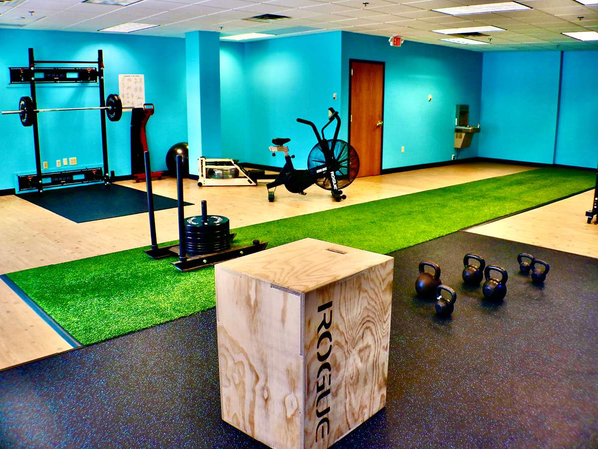 A gym room with a gym equipment and a box.