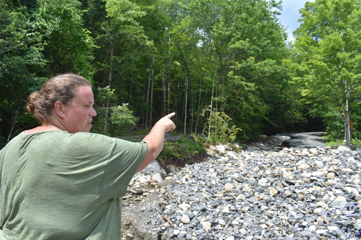 a woman pointing at a pile of rocks.