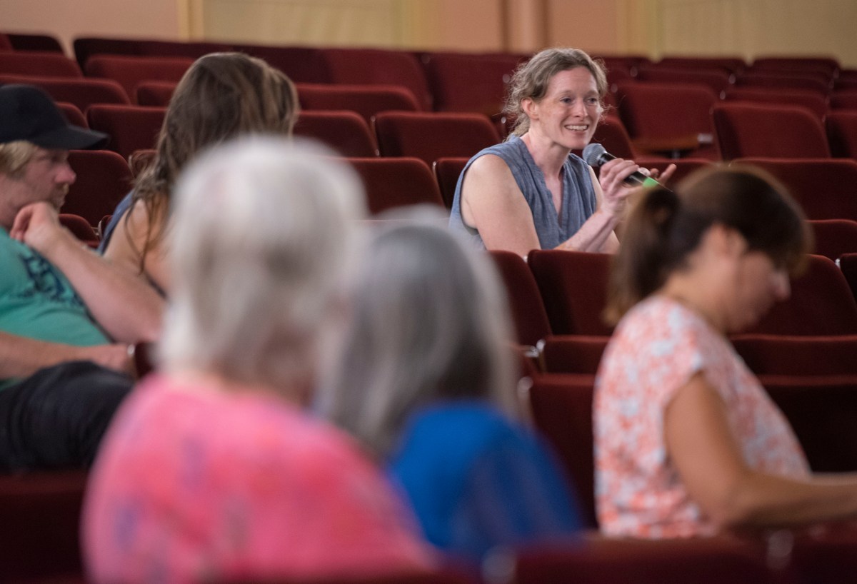 A group of people sitting in an auditorium.