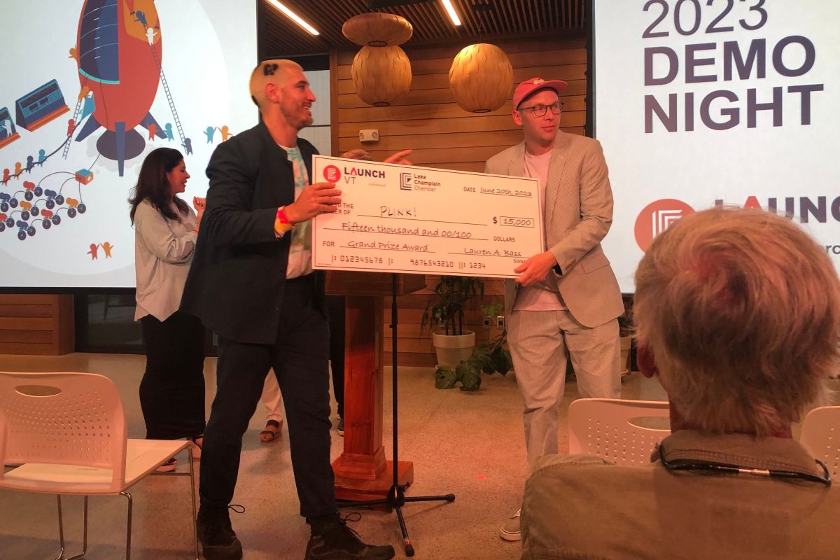 a man presenting a check to a group of people.