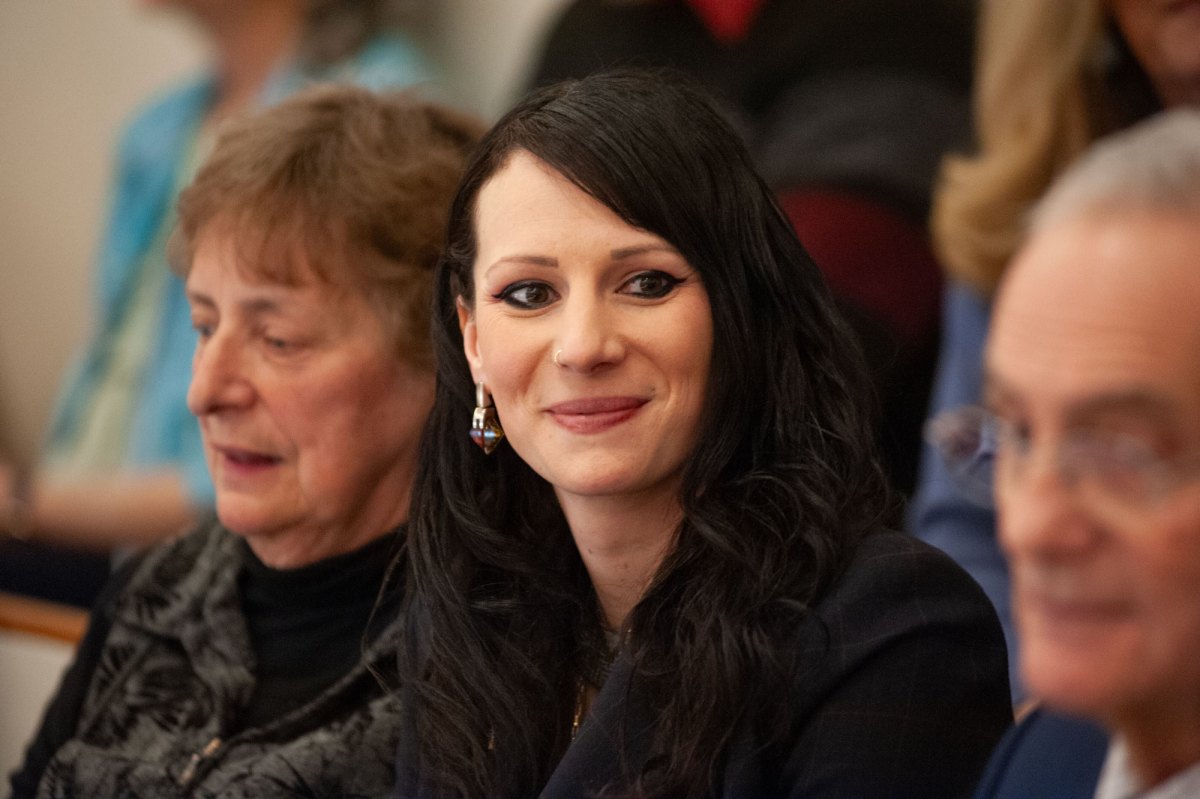 A woman looks to her left.